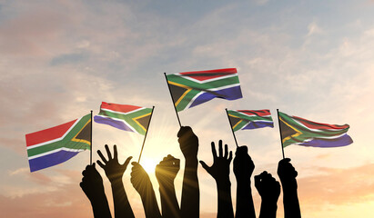 Silhouette of arms raised waving a South Africa flag with pride. 3D Rendering © ink drop