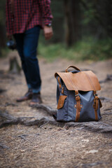 Hipster traveler with vintage backpack in nature