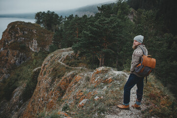 Fototapeta na wymiar Hipster traveler with vintage backpack in nature