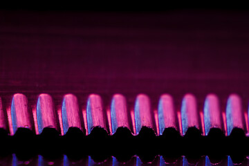 Edge of an illuminated  serrated knife and their reflection macro shot suitable as a background.