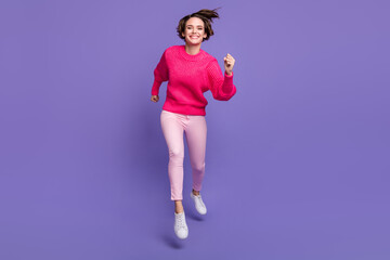 Fototapeta na wymiar Full body portrait of nice satisfied person running fast toothy smile wear pullover isolated on purple color background