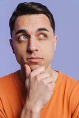 Young brunette white man thinking and looking aside