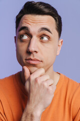 Young brunette white man thinking and looking aside