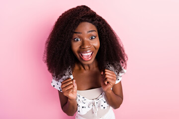 High angle view portrait of delighted dark skin person fists up open mouth isolated on pink color background