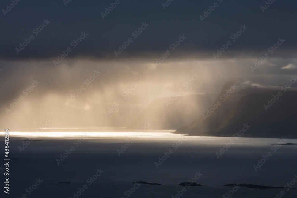 Canvas Prints Sunbeams over rocky coastline in Norway