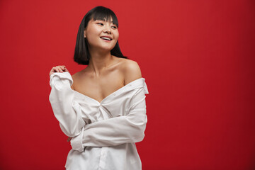 Young asian woman wearing shirt smiling while posing on camera