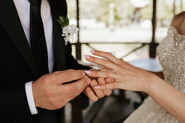 Bride and groom exchanging wedding rings during ceremony
