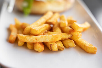 fresh and hot french fries on plate