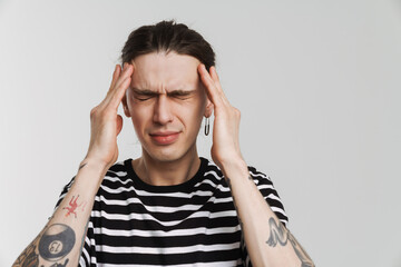 Young white man with headache rubbing his temples