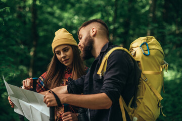 A couple of hikers using smartphone for orientation while spending time in nature
