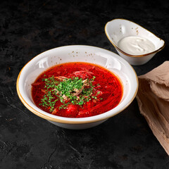 Traditional Ukrainian Russian borscht . Bowl of red beet root soup borsch with white cream . Beet Root delicious soup . Traditional Ukrain food cuisine