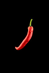 Chilli pepper isolated. Red hot chili paprika or spicy chile cayenne pepper isolated on black background. Ingredient for fresh spice mexican food.