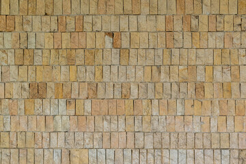 Stone wall of natural stones in different sizes. The facade of the house