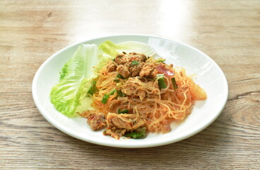 glass noodle with pork spicy salad and lettuce on plate