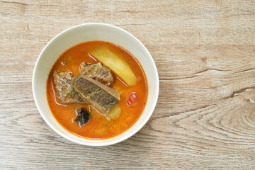 beef curry with slice potato and onion in bowl