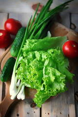 Set of greens on a wooden board. Green onions, salad, vegetables. Healthy diet. Salad products.