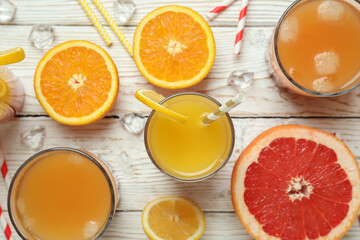 Tequila sunrise cocktail and ingredients on wooden table