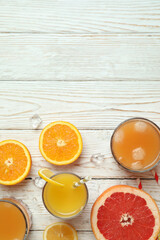 Tequila sunrise cocktail and ingredients on wooden table