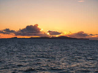 Sunset over the island of Fair Isle, part of the Shetland archipelago in the north of the UK. Taken...