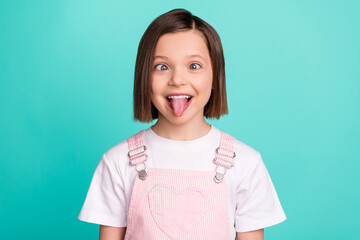 Photo of funky happy cheerful young little girl make funny face good mood isolated on teal color...