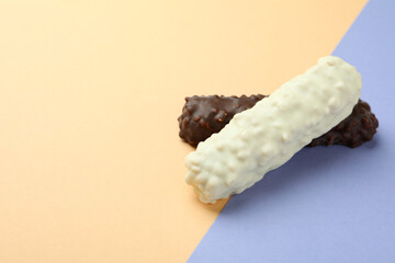 Tasty candy bars on two tone background