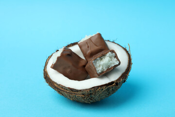 Coconut with candy bars on blue background