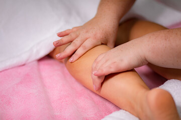Obraz na płótnie Canvas facial and body foot massage procedure in the spa salon