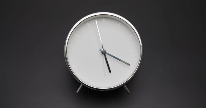 silver clock isolated on white background, Time starts walking at 5 o'clock, Time lapse 3 hour.
