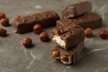 Candy bars and nuts on gray textured table