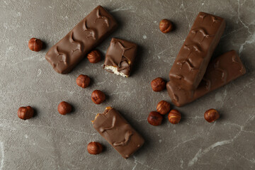 Candy bars and nuts on gray textured table