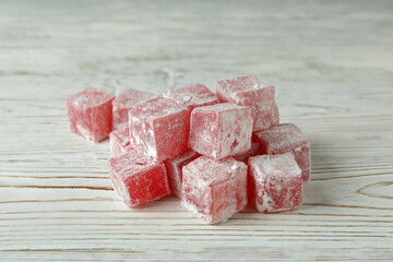 Delicious turkish delight cubes on wooden background