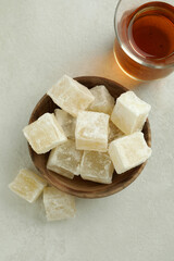 Tea and delicious turkish delight on white textured background