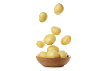 Bowl and falling young potato isolated on white background
