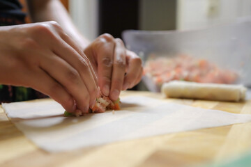 person preparing springrolls 