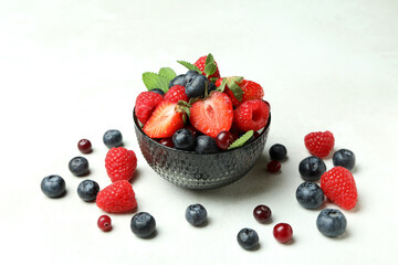 Bowl with berry mix on white background