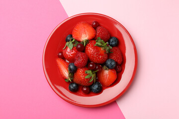 Plate with berry mix on two tone background