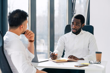 Business meeting in office. Employment interview. Two business partners are talking while sitting...