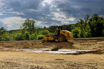 Obraz premium Under construction of a new road excavators, graders and road working on the construction site