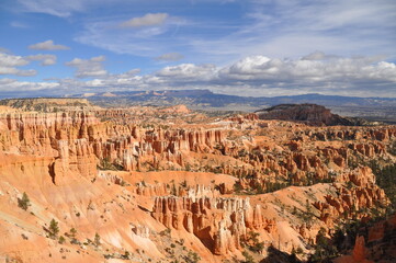 Panoramic view of  huge rocky terrain, pinnacles and cliffs under cloudy sky  in Paunsaugunt Plateau of Bryce Canyon National Park, USA