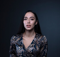 portrait of a young woman in the studio on a dark background