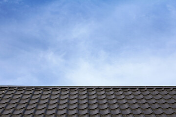 metal roof against a blue sky with clouds. protection of real estate