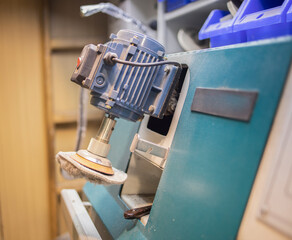 machine, equipment for repairing shoes in the workshop, under the light of lamps, indoors. Shoe machine, workstation for a craftsman, shoemaker. 