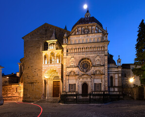 Night view of the Basilica of Santa Maria Maggiore in the Upper Town, Bergamo, Italy. Red trail...