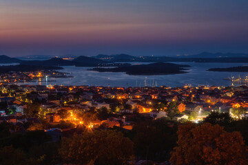 Amazing panoramic view of Murter-Kornati town, sea and Kornati islands, scenic night landscape with lights, Murter otok, Dalmatia, Croatia. Outdoor travel background