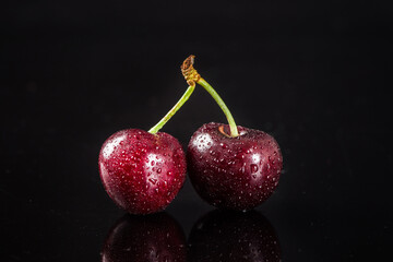 Cherries fruit isolated on black background.