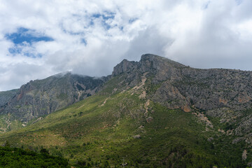 Fototapeta na wymiar Steep mountains in the interior of the province of Alicante (Spain) covered with clouds.