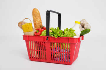close up of shopping basket full of healthy food over white