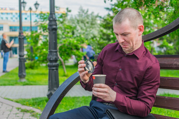 An office worker on a park bench opened a glass of coffee and was unpleasantly surprised at its...