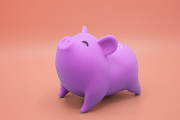 Piggy bank on orange background. Finance, saving money concept.