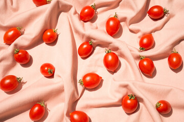 Fototapeta na wymiar Cherry tomato pattern on pink background